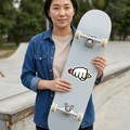 Woman holding a skateboard with the Power of Writing sticker